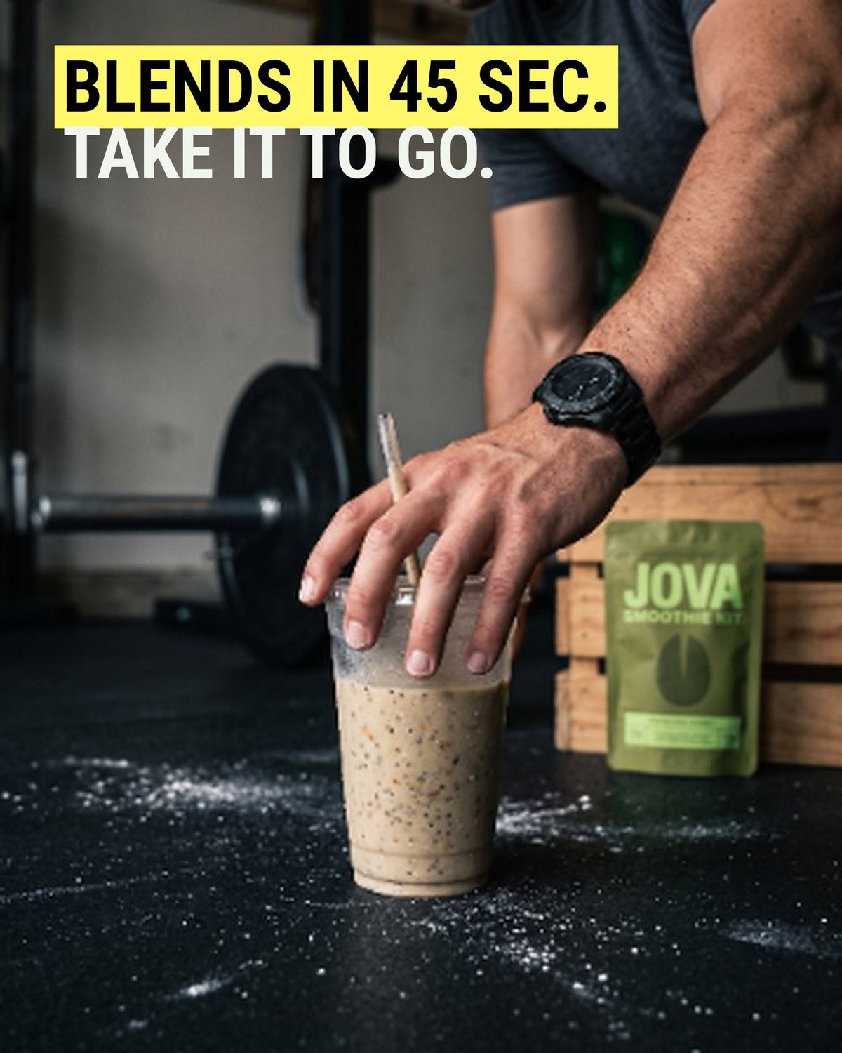 Man at the gym setting down a JOVA protein smoothie in a to-go cup, pistachio smoothie kit behind it